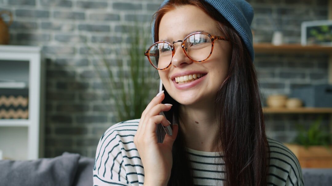 Young woman having a phone conversation at home